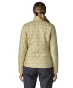Back of woman wearing Patagonia's women's nano puff jacket weathered stone lightweight insulated jacket showing brick quilting 
