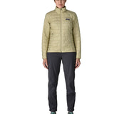 Woman wearing Patagonia nano puff jacket in weathered stone. Jacket has a regular fit