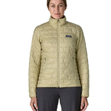 Woman wearing Patagonia's nano puff jacket in weathered stone fully zipped