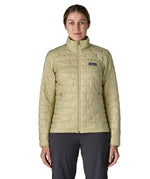 Woman wearing Patagonia's nano puff jacket in weathered stone fully zipped