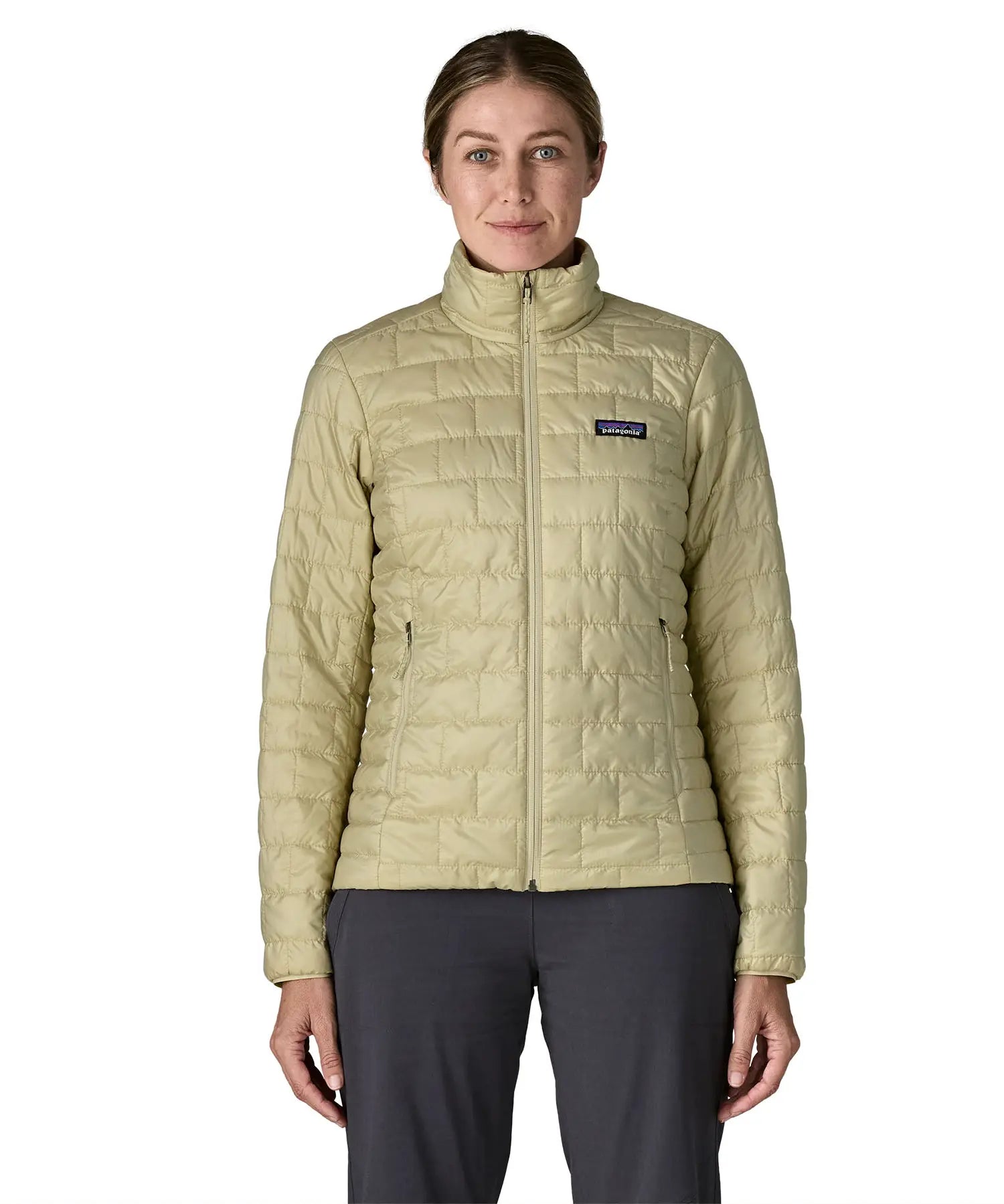 Woman wearing Patagonia's nano puff jacket in weathered stone fully zipped