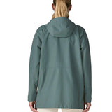 Back of woman wearing Patagonia outdoor everyday rain jacket in blue with the hood down.