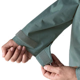 Woman wearing Patagonia outdoor everyday rain jacket in blue sage showing close up of a open cuff velcro 
