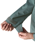 Woman wearing Patagonia outdoor everyday rain jacket in blue sage showing close up of a open cuff velcro 