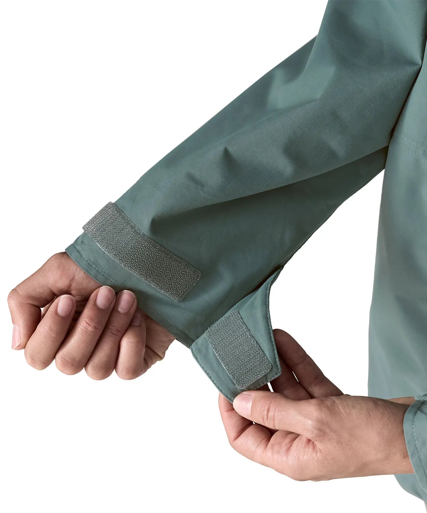 Woman wearing Patagonia outdoor everyday rain jacket in blue sage showing close up of a open cuff velcro 