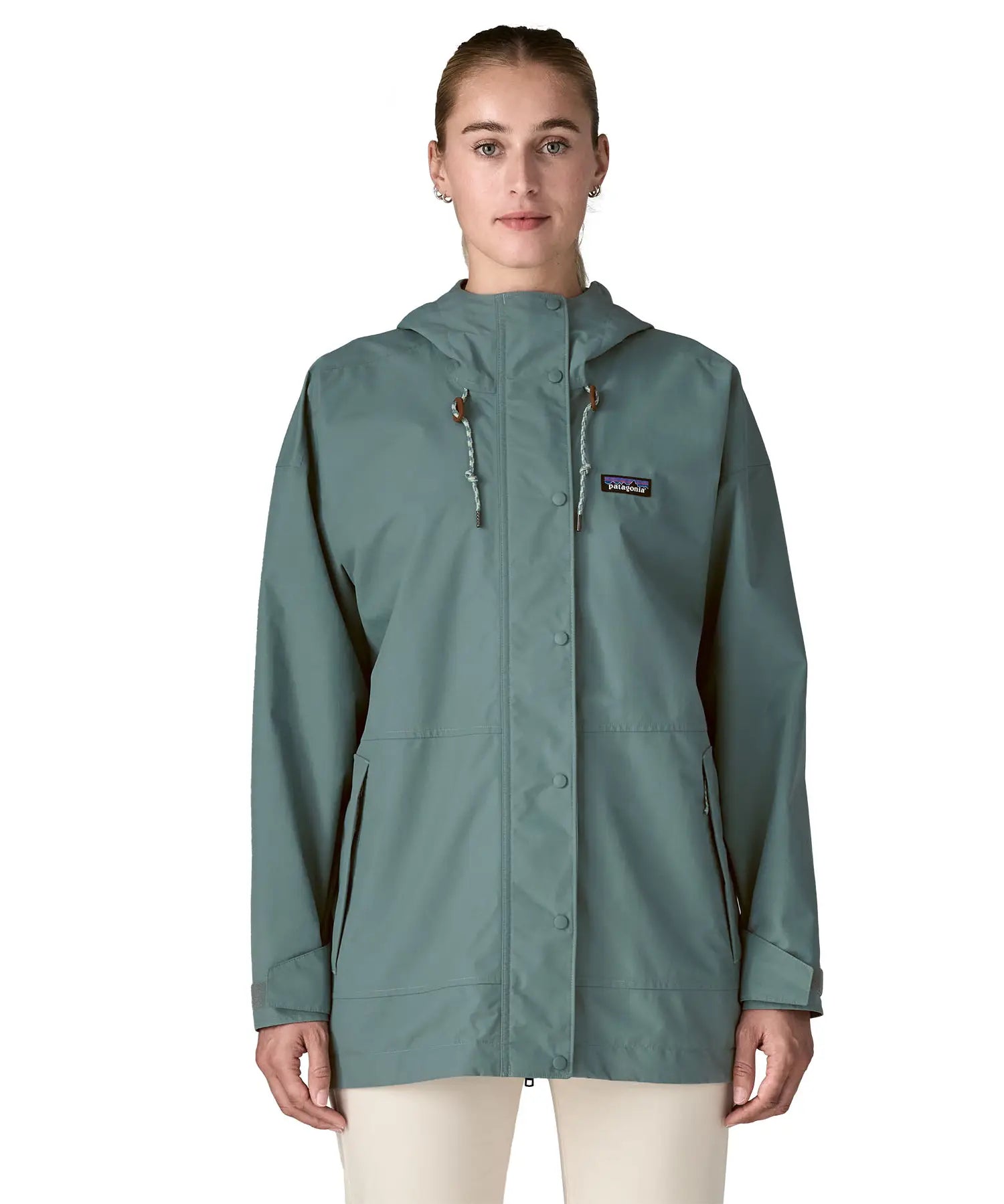 Woman wearing Patagonia outdoor everyday rain jacket in blue sage full zipped showing hood toggles. Coat has a relaxed fit