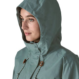 Woman wearing Patagonia outdoor everyday rain jacket in blue sage showing close up the adjustable hood