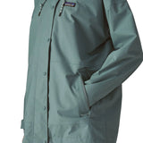 Woman wearing Patagonia outdoor everyday rain jacket in blue sage showing hand in side pocket
