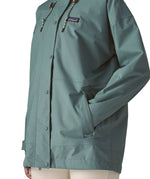Woman wearing Patagonia outdoor everyday rain jacket in blue sage showing hand in side pocket