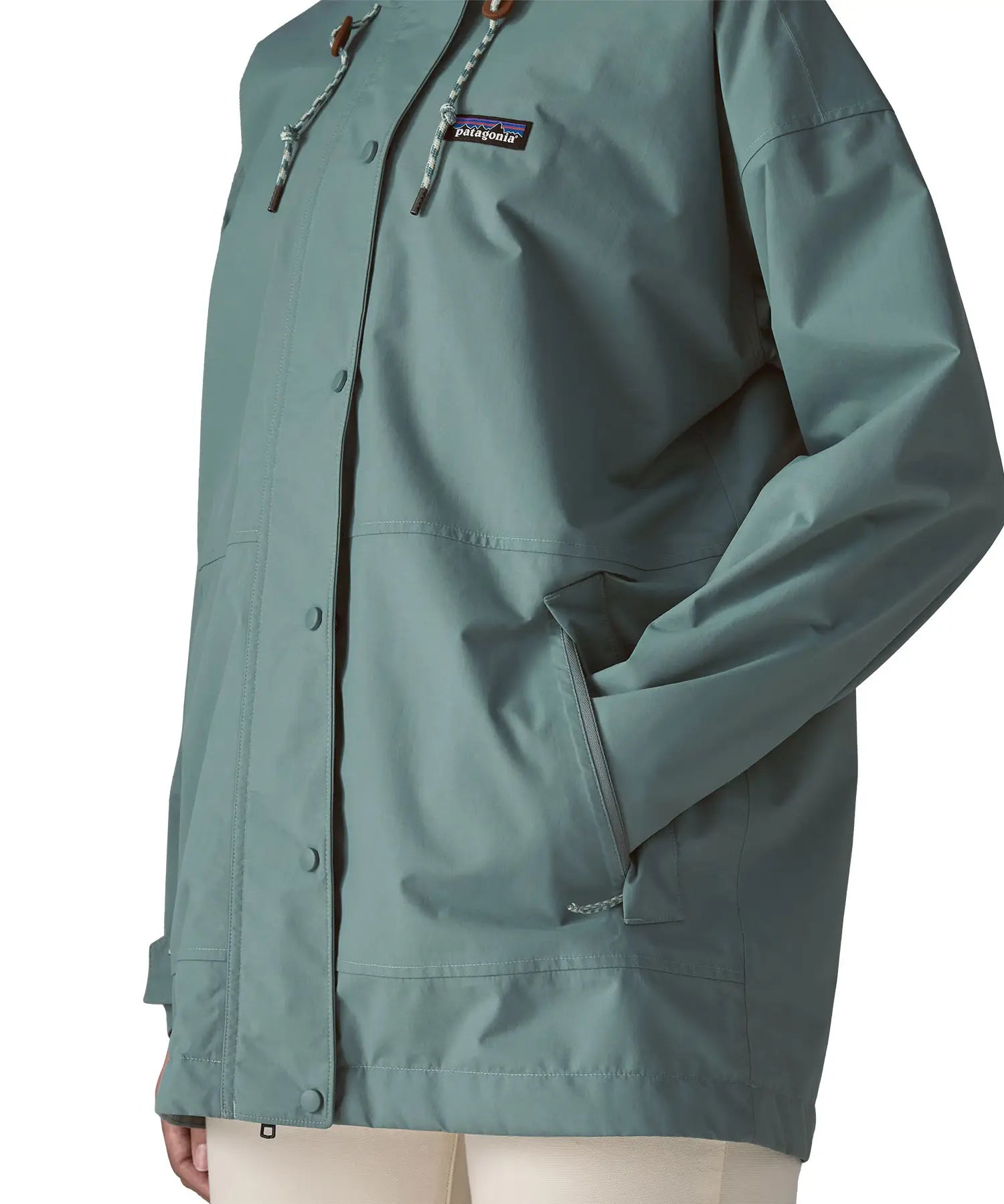 Woman wearing Patagonia outdoor everyday rain jacket in blue sage showing hand in side pocket