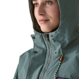 Woman wearing Patagonia outdoor everyday rain jacket in blue sage showing close up front zip and popper fastener
