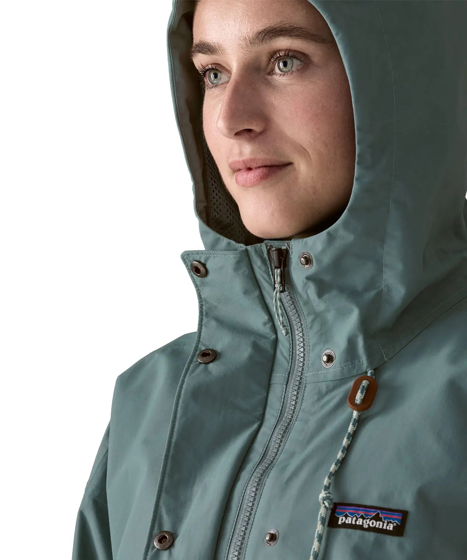 Woman wearing Patagonia outdoor everyday rain jacket in blue sage showing close up front zip and popper fastener
