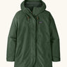 Patagonia women's outdoor everyday rain jacket in dark green. Features a full length zip and popper fastener, side pockets and adjustable hood