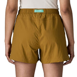 Back of woman wearing Patagonia's women's outdoor everyday shorts in brown. Shorts have a loose fit and sit above the knees