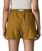 Back of woman wearing Patagonia's women's outdoor everyday shorts in brown. Shorts have a loose fit and sit above the knees