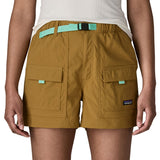 Woman wearing Patagonia's women's outdoor everyday shorts in brown. Shows front pockets. Shorts have a loose fit