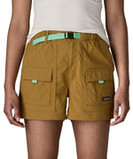 Woman wearing Patagonia's women's outdoor everyday shorts in brown. Shows front pockets. Shorts have a loose fit
