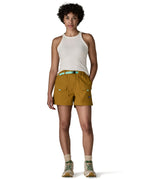 Woman wearing Patagonia's women's outdoor everyday shorts in brown with hand in side pocket. Shorts have a loose fit and sit over the knees