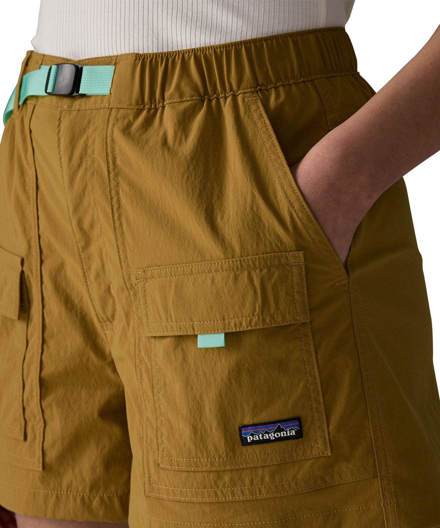 Close up of woman wearing Patagonia women's outdoor everyday quick drying shorts in brown with hand in side pocket