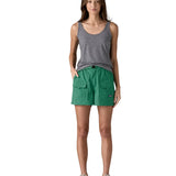 Front of Woman wearing Patagonia's women's outdoor everyday shorts in green. Shorts have a loose fit and sit above the knees