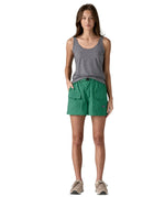 Front of Woman wearing Patagonia's women's outdoor everyday shorts in green. Shorts have a loose fit and sit above the knees