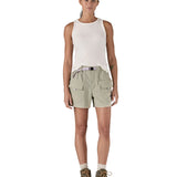 Front of Woman wearing Patagonia's women's outdoor everyday shorts in light grey. Shorts have a loose fit and sit over the knees