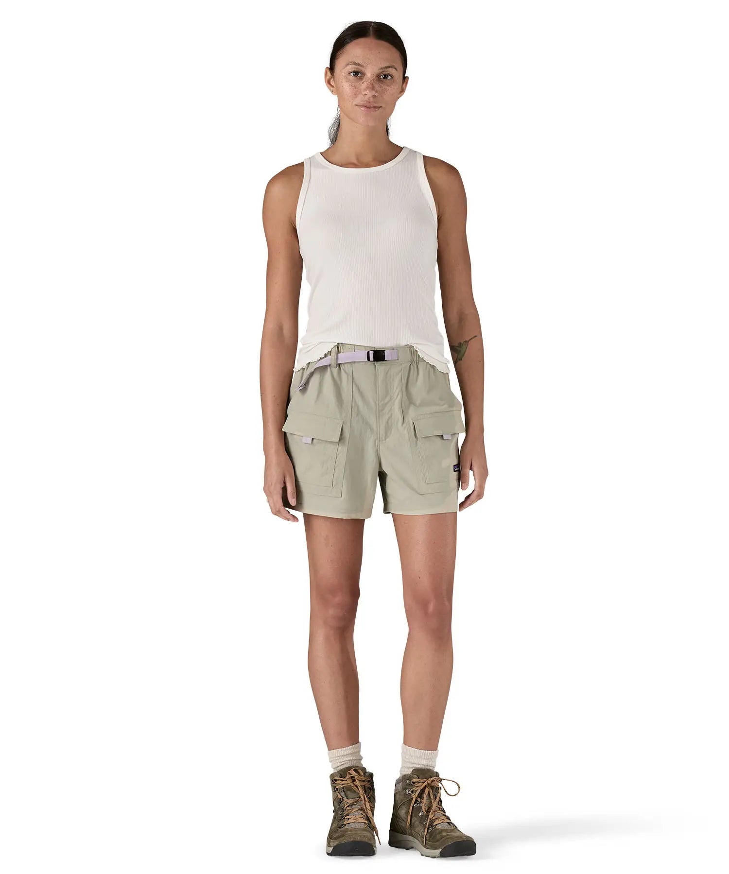 Front of Woman wearing Patagonia's women's outdoor everyday shorts in light grey. Shorts have a loose fit and sit over the knees