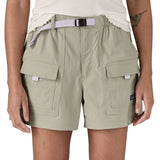 Woman wearing Patagonia's women's outdoor everyday shorts in light grey. Shows front pockets. Shorts have a loose fit