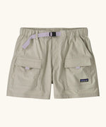 Patagonia women's outdoor everyday quick drying shorts in light grey. Shows side and front pockets and purple belt.