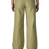 A close up of the back of the female standing in front of a white background wearing a white t-shirt and the Patagonia women's canvas trousers with a wide leg in light green colour showing the leg length and back pocket