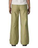 A close up of the back of the female standing in front of a white background wearing a white t-shirt and the Patagonia women's canvas trousers with a wide leg in light green colour showing the leg length and back pocket