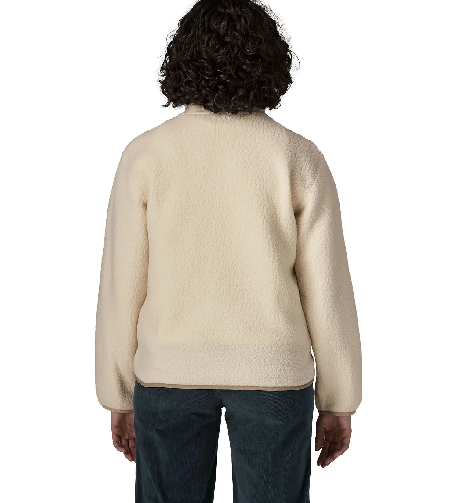 Back of woman wearing Patagonia's retro pile fleece jacket in natural cream showing a beige trim on the hem and cuff