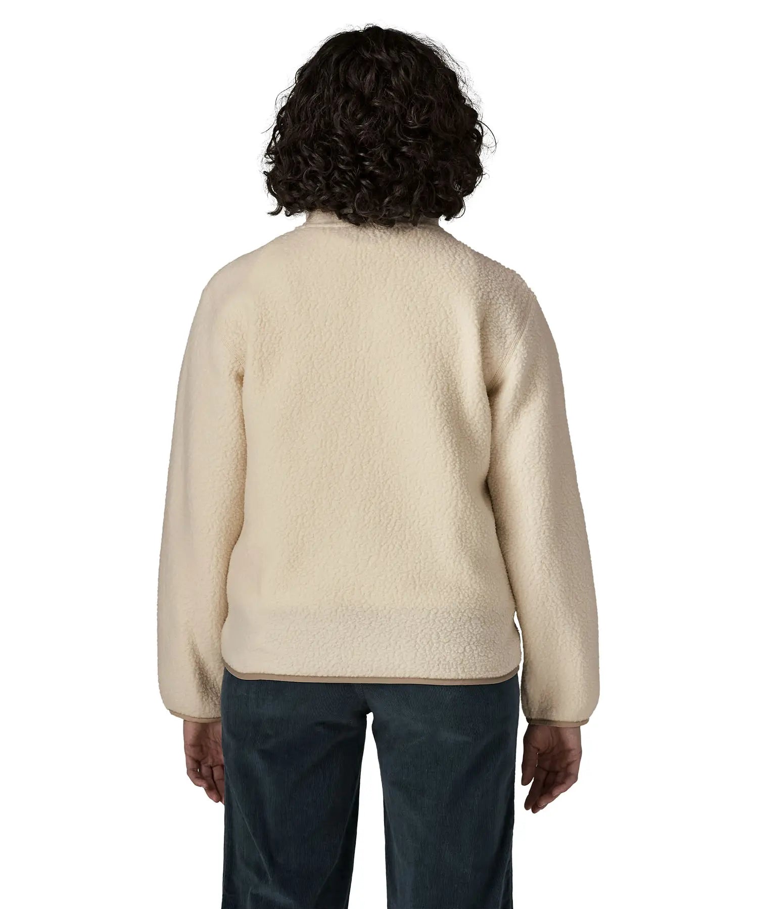 Back of woman wearing Patagonia's retro pile fleece jacket in natural cream showing a beige trim on the hem and cuff