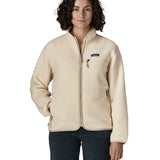 Woman wearing Patagonia's retro pile fleece jacket in natural cream. showing full front zip, chest and side pocket. fleece has a relaxed fit