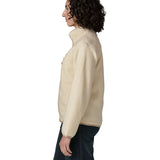 Side of woman wearing Patagonia's retro pile fleece jacket in natural cream. showing the stand up collar
