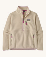 Patagonia women's thick fleece jacket in light cream. Features a half length front zip with side and chest pockets.
