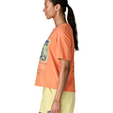 Side of woman Patagonia women's easy cut short sleeve t-shirt in bright orange. T-shirt has a boxy fit and sits at the hips