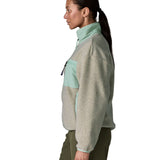 Side of woman wearing Patagonia women's synchilla fleece jacket in light grey and blue trim