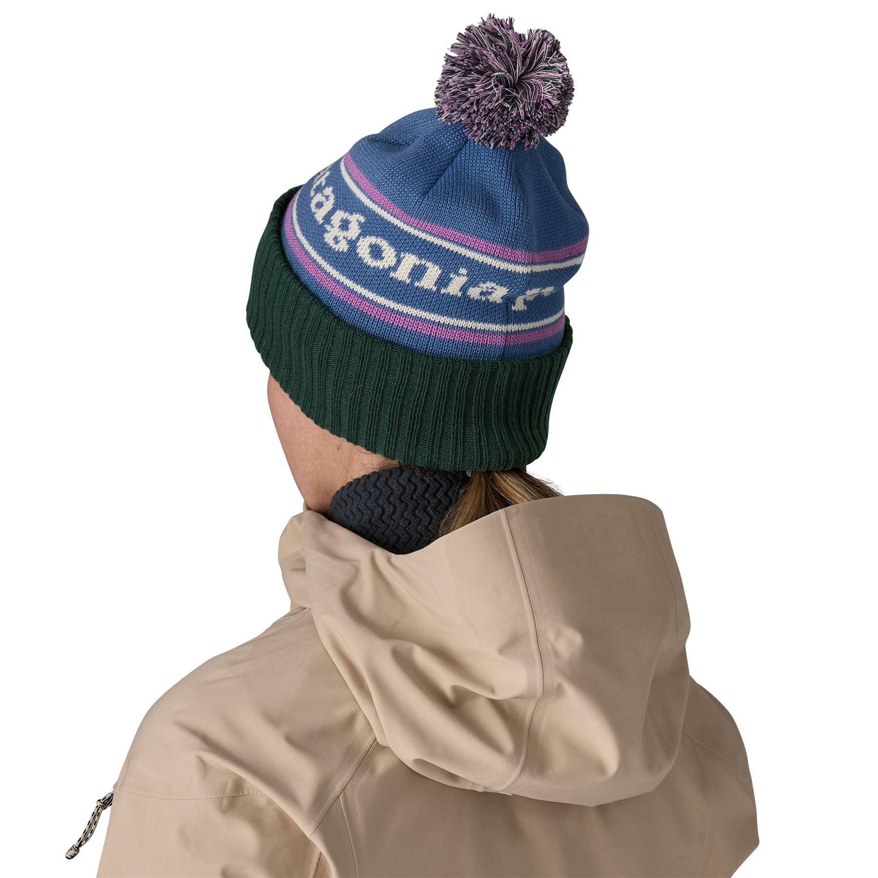 The back of a woman wearing the Patagonia adult powder town beanie in park stripe and barnacle blue colourway available at Babipur.