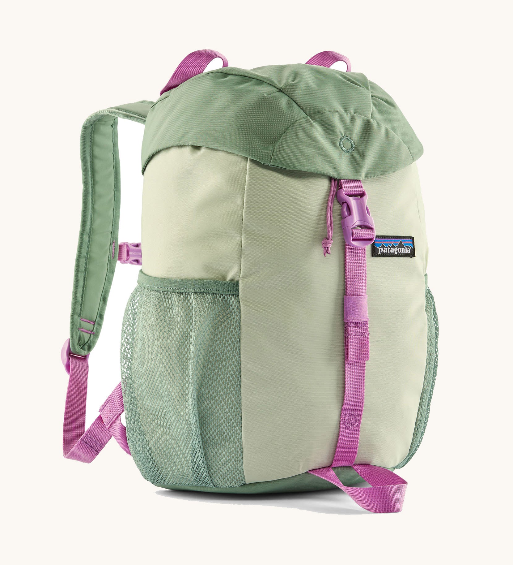 The Patagonia Kids Refugito 12L Backpack   in ellwood green , a pastel green backpack pink buckle and handle detail. Features 2 side mesh pockets in contrast green. A Logo patch is stitched on the front panel.