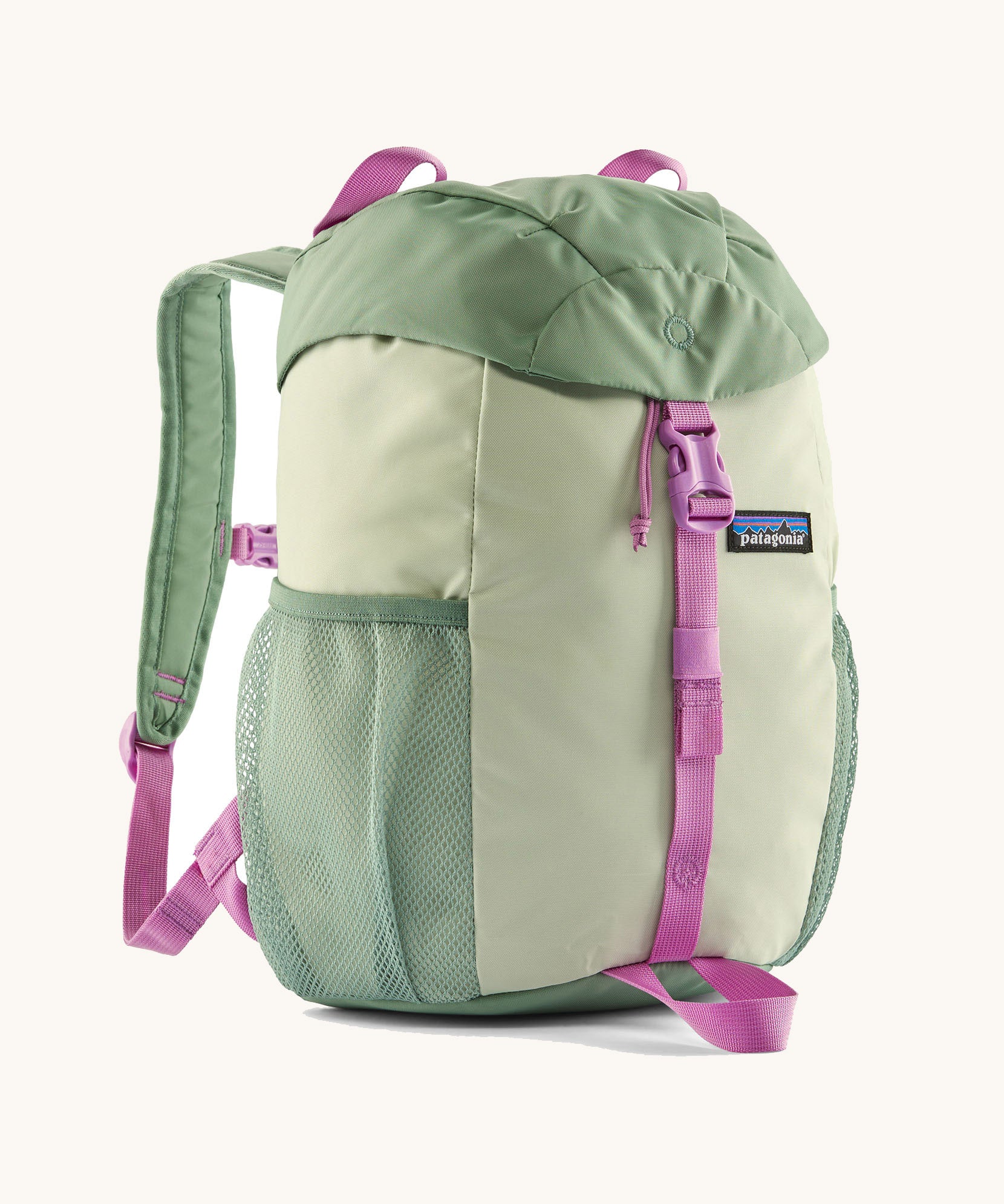 The Patagonia Kids Refugito 12L Backpack   in ellwood green , a pastel green backpack pink buckle and handle detail. Features 2 side mesh pockets in contrast green. A Logo patch is stitched on the front panel.