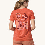 An adult wearing a Patagonia Women's Cap Cool Daily Graphic Shirt, showing the fit of the top from the back