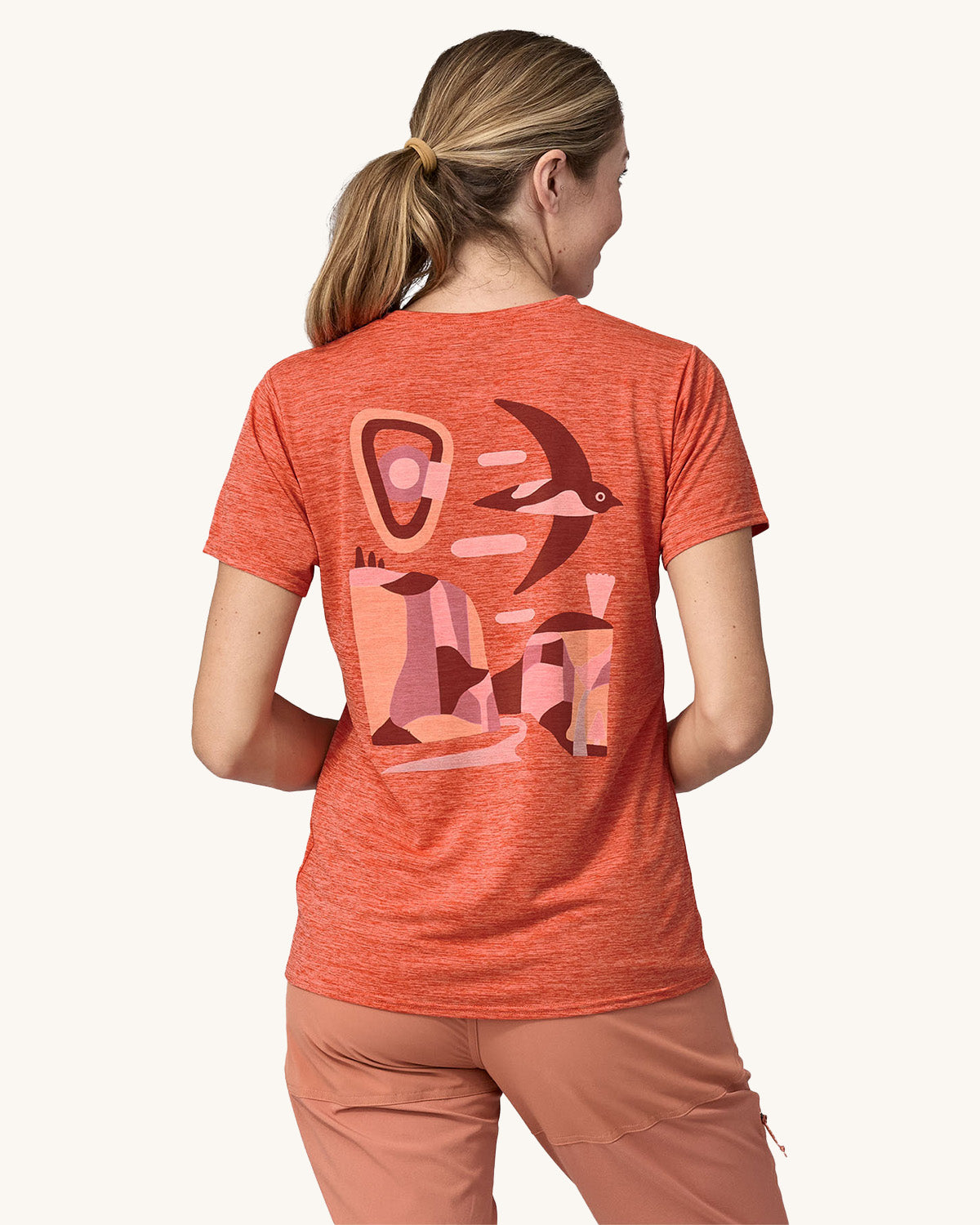 An adult wearing a Patagonia Women's Cap Cool Daily Graphic Shirt, showing the fit of the top from the back