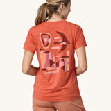 An adult wearing a Patagonia Women's Cap Cool Daily Graphic Shirt, showing the fit of the top from the back