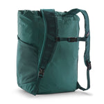 Back view of the Patagonia Terravia tote bag in cascade green colour showing the grey strap detail with buckle for fastening. Features side pockets for holding bottles.