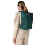 Patagonia Terravia tote bag in cascade green worn by a adult on the back available at Babipur showing the carrying handle details and side pockets for holding bottles