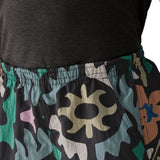 Woman wearing Patagonia quick drying women's baggies shorts in black with repeating abstract design shows elasticated waist band