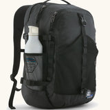 Patagonia 30L refugio backpack in black with side bottle holder and black gear loops and quick release buckles.