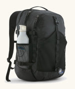 Patagonia 30L refugio backpack in black with side bottle holder and black gear loops and quick release buckles.