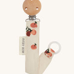 Avery Row Pacifier Holder - Peaches, showing the silicone ring and wooden clip